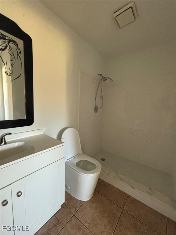 5713 Foxlake Drive, Unit 1 North Fort Myers, FL 33917 - Photo 7 of 10 a bathroom with a toilet sink and mirror
