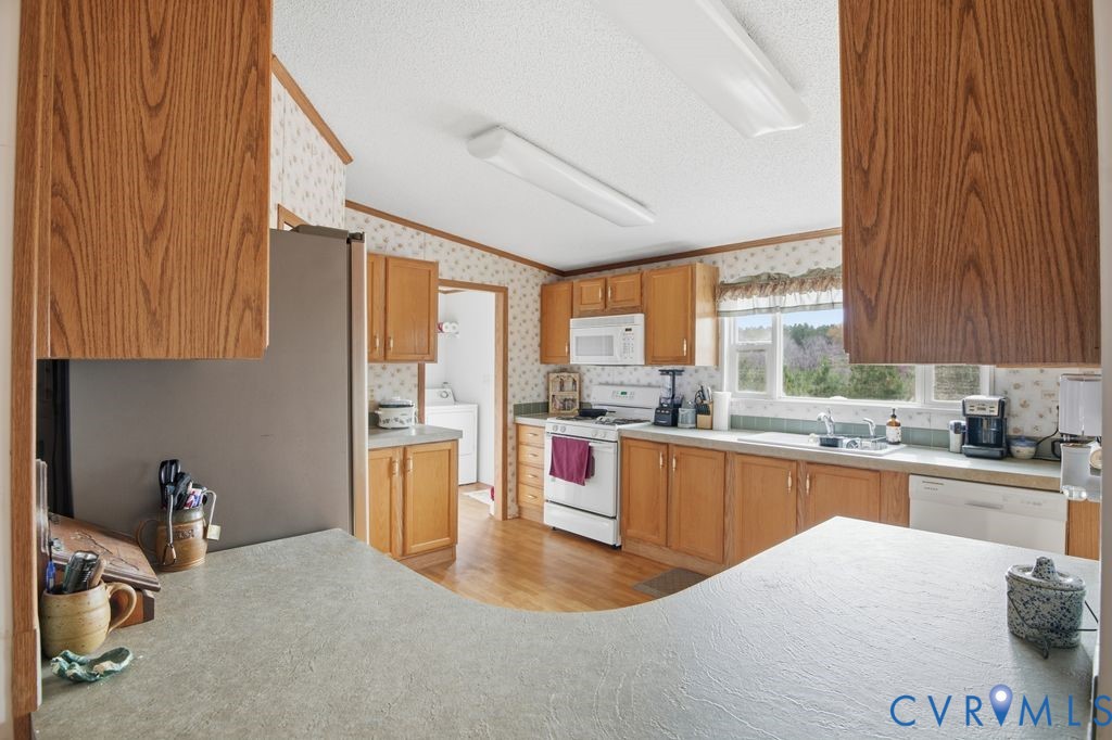 25825 Ridge Lane McKenney, VA 23872 - Photo 17 of 48 a kitchen with stainless steel appliances granite countertop a stove a sink dishwasher and a refrigerator with wooden cabinets
