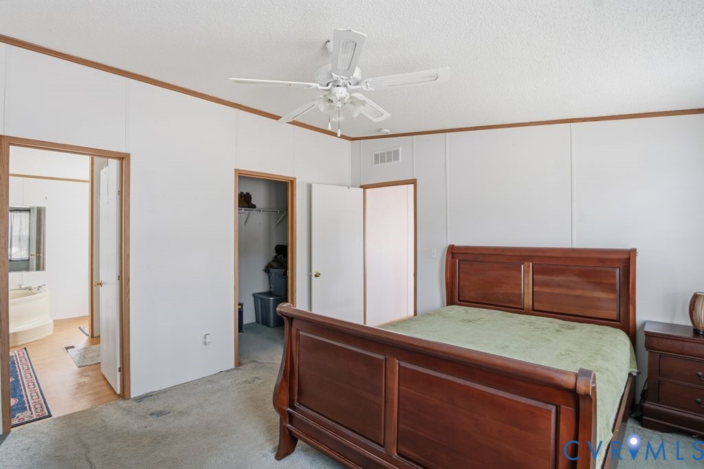 25825 Ridge Lane McKenney, VA 23872 - Photo 22 of 48 a room with a bed and a chandelier