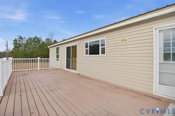 a view of a house with a wooden deck