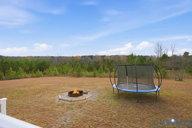 a backyard of a house with table and chairs