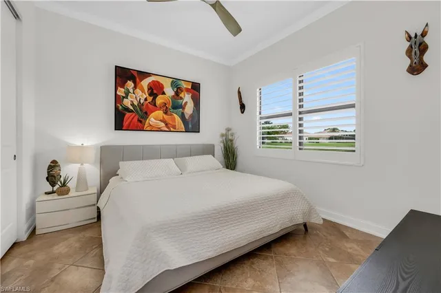 a bedroom with a bed and a painting on the wall