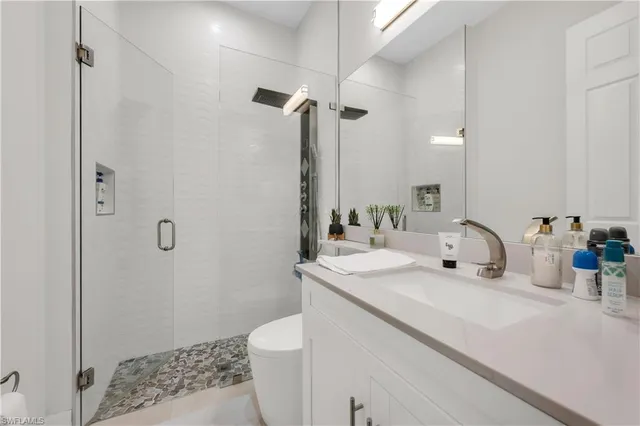 a bathroom with a sink toilet and shower