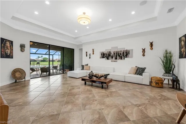 a living room with furniture and large window