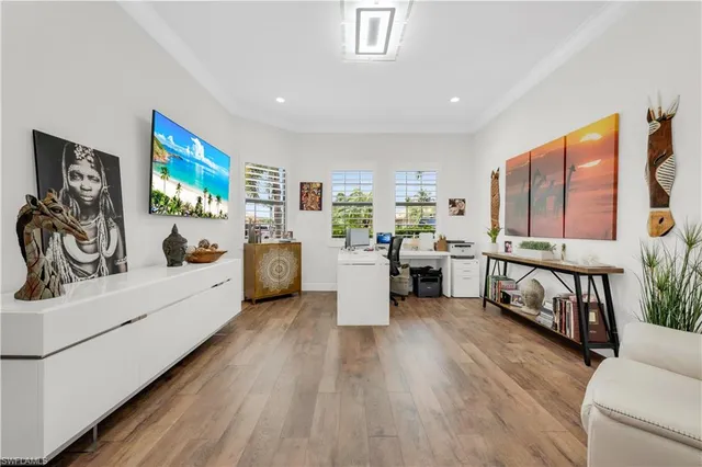 a large white room with stainless steel appliances furniture and a large window