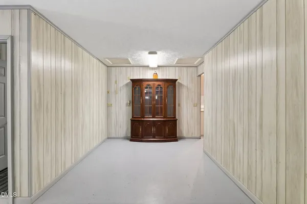 an empty room with wooden floor window and a ceiling fan