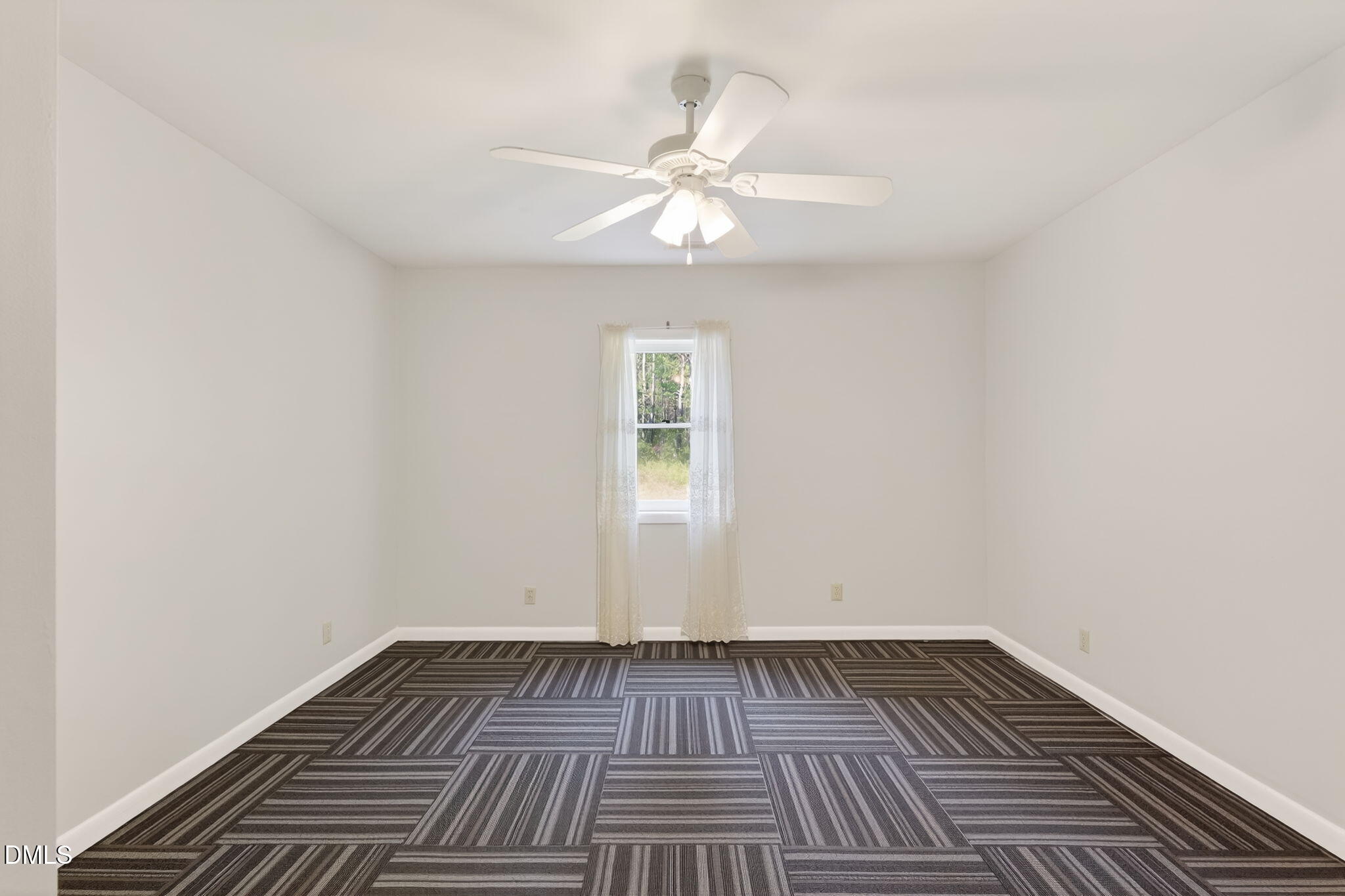 5363 Scottie Godwin Road Wade, NC 28395 - Photo 20 of 87 an empty room with wooden floor window and a ceiling fan