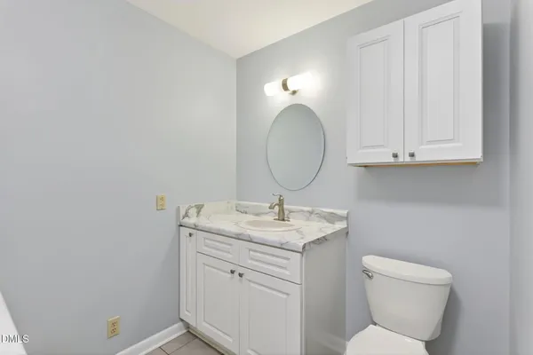 a kitchen with stainless steel appliances granite countertop a sink and a white cabinets
