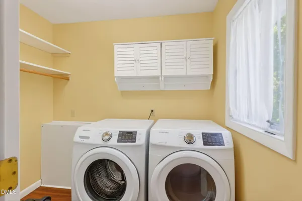 a large white kitchen with a large window