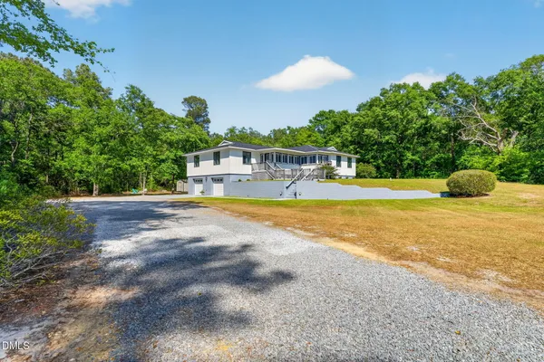 a view of a house with swimming pool and a yard