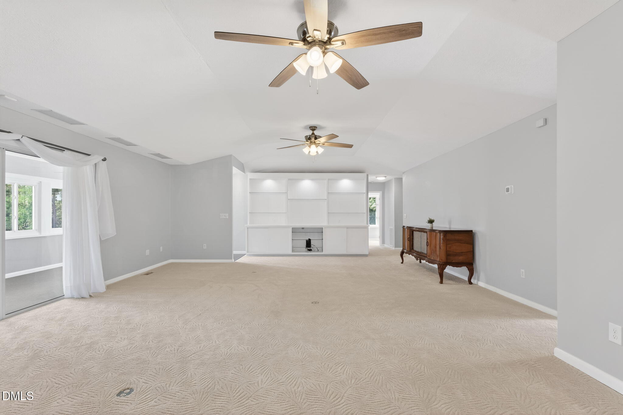 5363 Scottie Godwin Road Wade, NC 28395 - Photo 34 of 87 an empty room with chandelier fan and windows