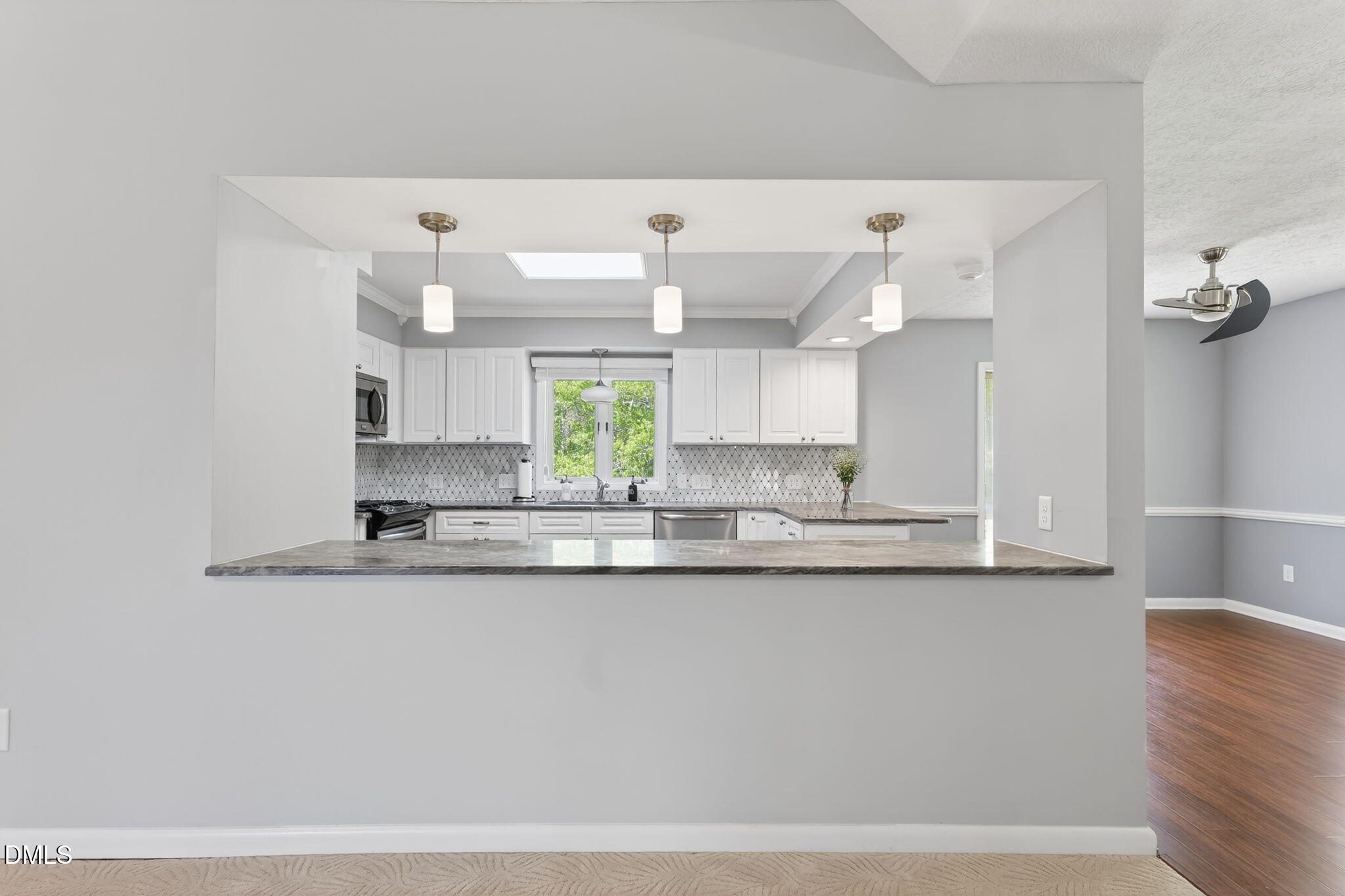 5363 Scottie Godwin Road Wade, NC 28395 - Photo 35 of 87 a kitchen with stainless steel appliances granite countertop a sink and a white cabinets
