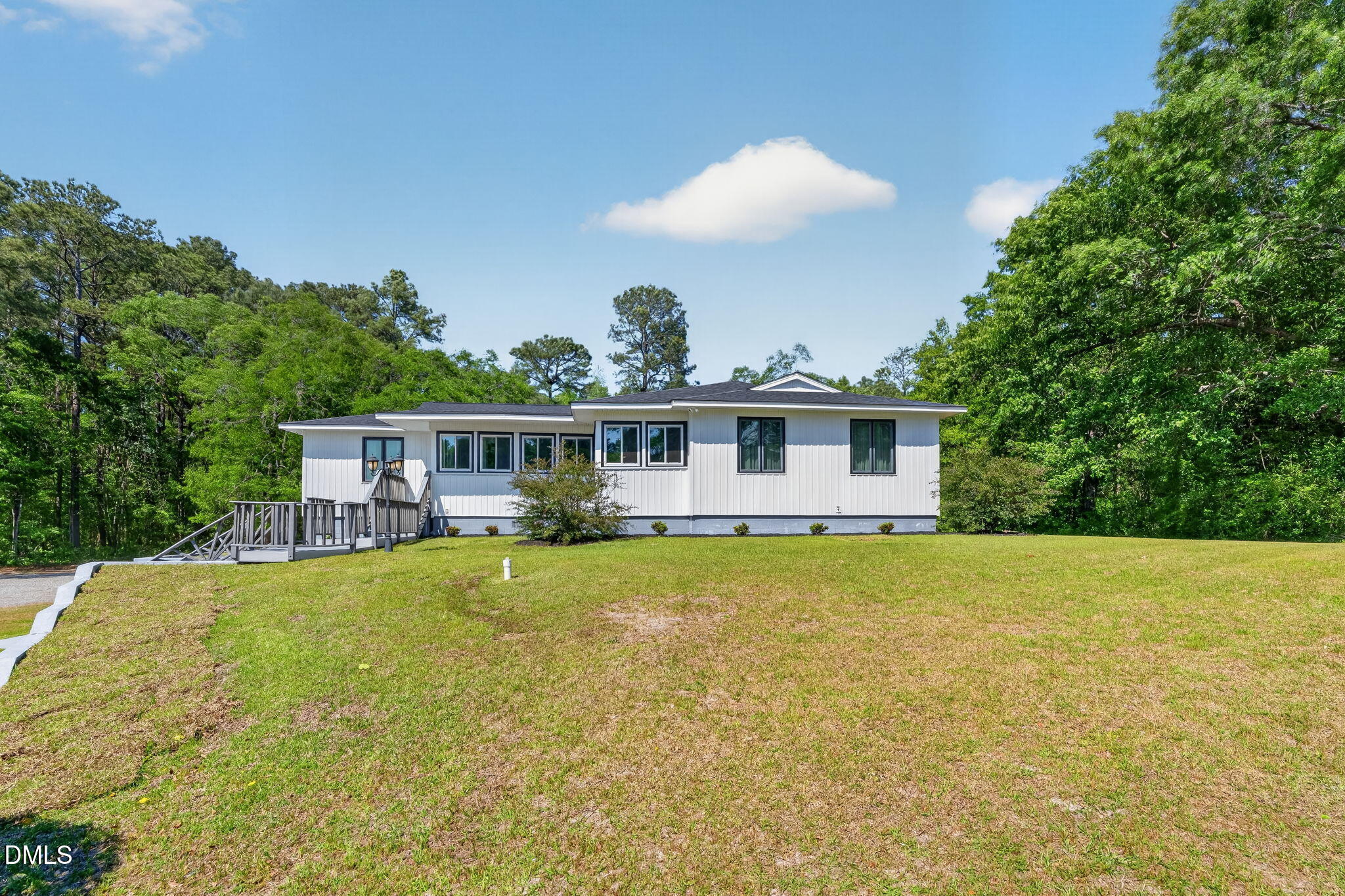5363 Scottie Godwin Road Wade, NC 28395 - Photo 4 of 87 a front view of a house with a garden