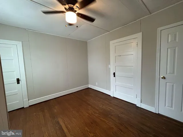 a view of an empty room and wooden floor