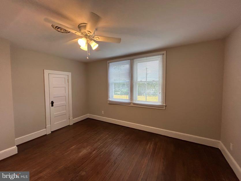 15471 U.S. Rte 1 Woodford, VA 22580 - Photo 22 of 74 a view of an empty room with wooden floor and a window