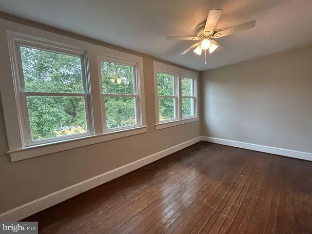 a view of a room with wooden floor