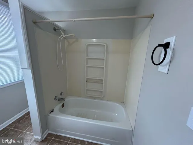 a front view of house with yard and trees in the background