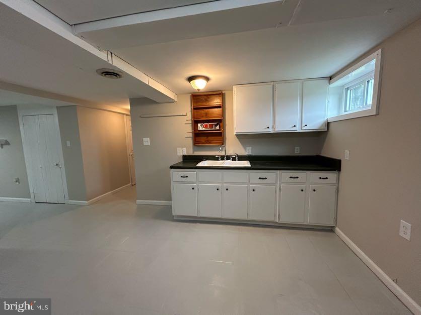 15471 U.S. Rte 1 Woodford, VA 22580 - Photo 46 of 74 a view of cabinets stainless steel appliances wooden floor and a window