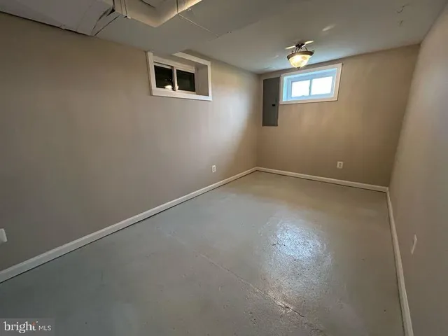 a view of outdoor space with field and trees in the background