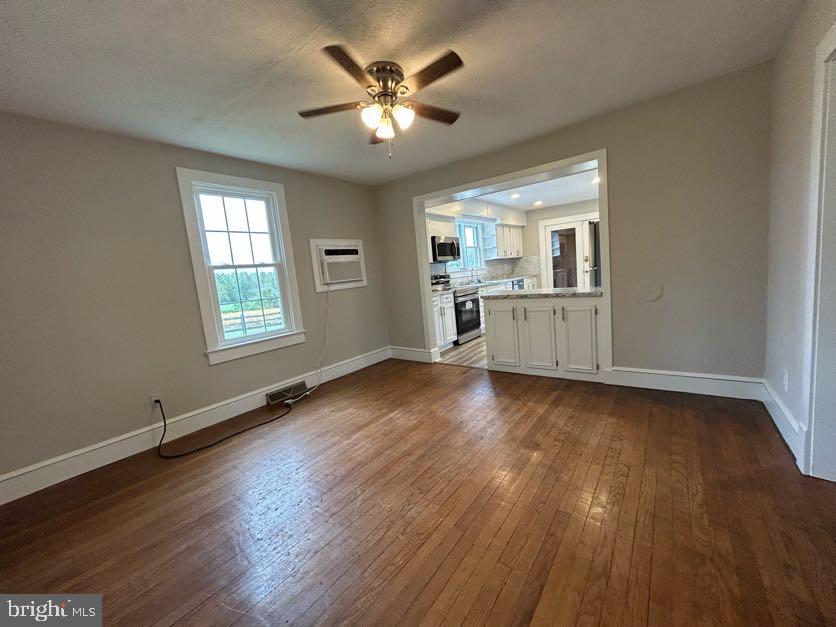 15471 U.S. Rte 1 Woodford, VA 22580 - Photo 8 of 74 an empty room with wooden floor and windows