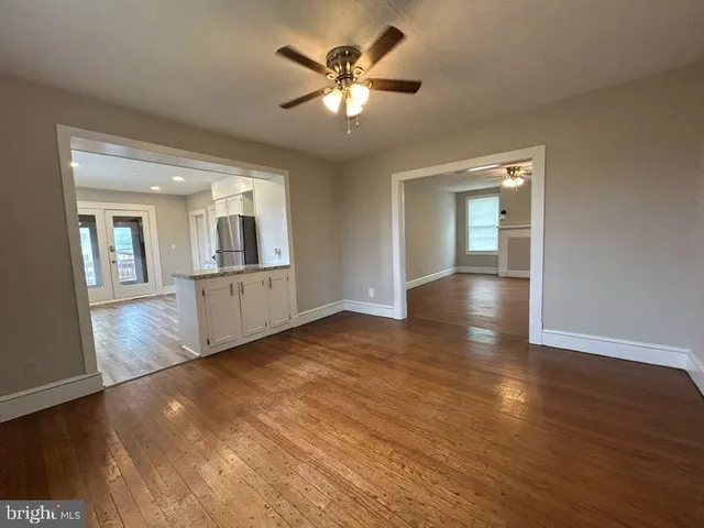 a kitchen with granite countertop a refrigerator stove top oven and sink
