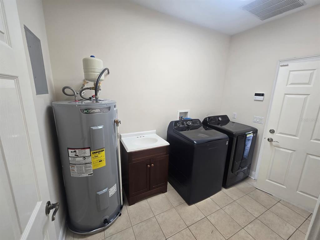 6930 Piazza Street Orlando, FL 32819 - Photo 12 of 25 a view of water heater room