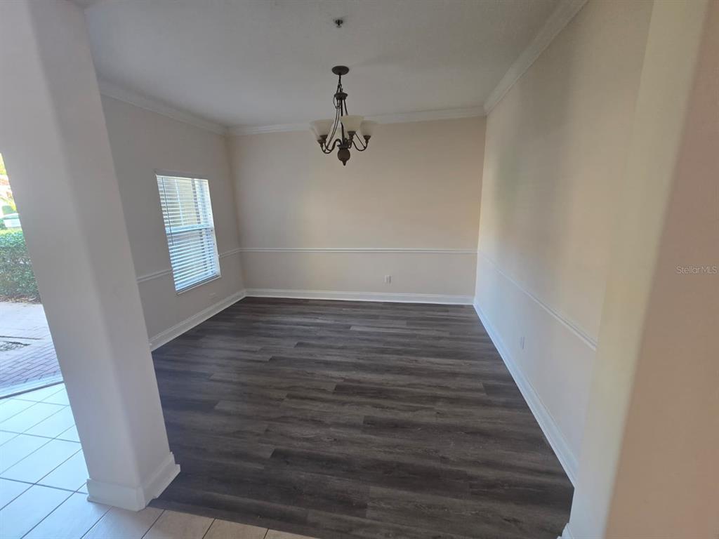 6930 Piazza Street Orlando, FL 32819 - Photo 13 of 25 a view of a hallway with wooden floor and staircase