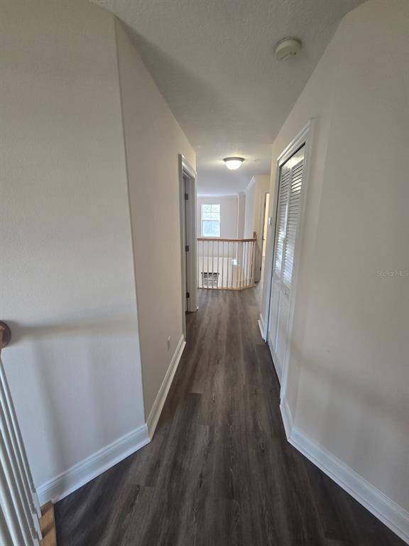6930 Piazza Street Orlando, FL 32819 - Photo 15 of 25 a view of hallway with wooden floor