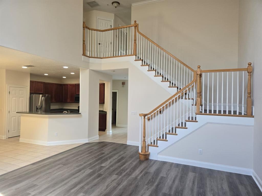 6930 Piazza Street Orlando, FL 32819 - Photo 6 of 25 a view of entryway and hall with wooden floor