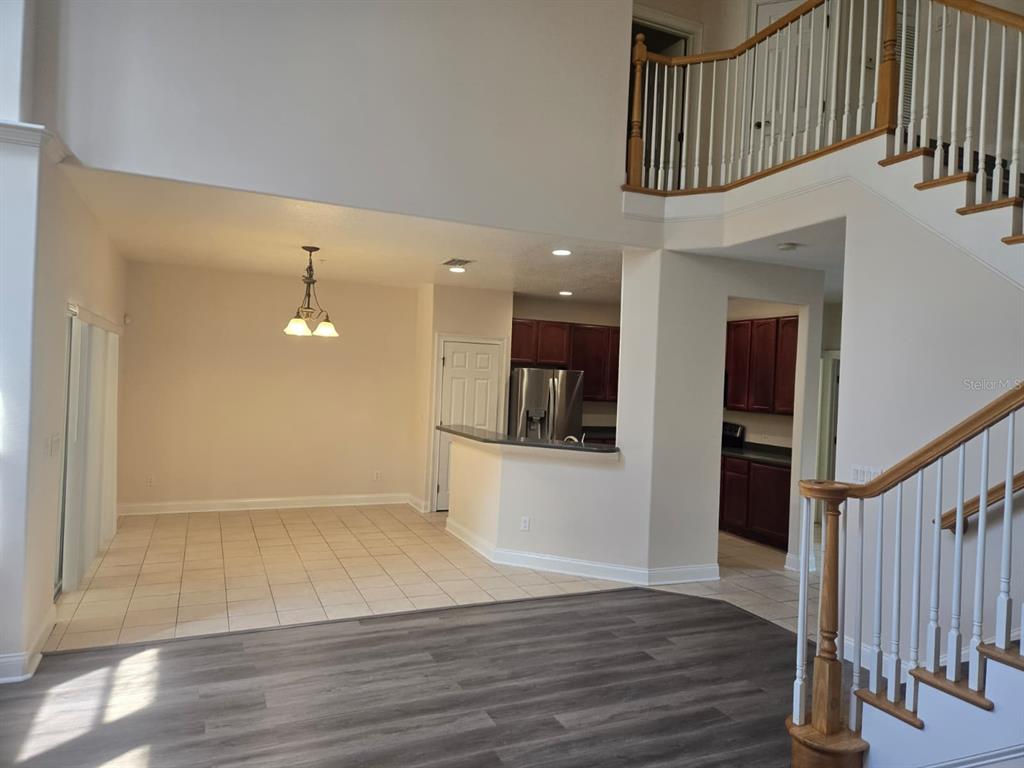 6930 Piazza Street Orlando, FL 32819 - Photo 7 of 25 a view of a hallway with wooden floor and staircase