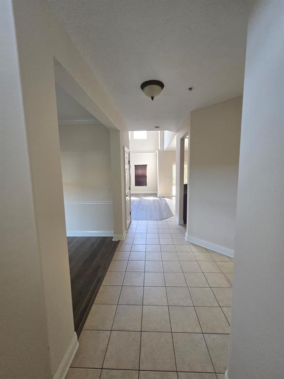 6930 Piazza Street Orlando, FL 32819 - Photo 10 of 25 a view of hallway with a window and a mirror