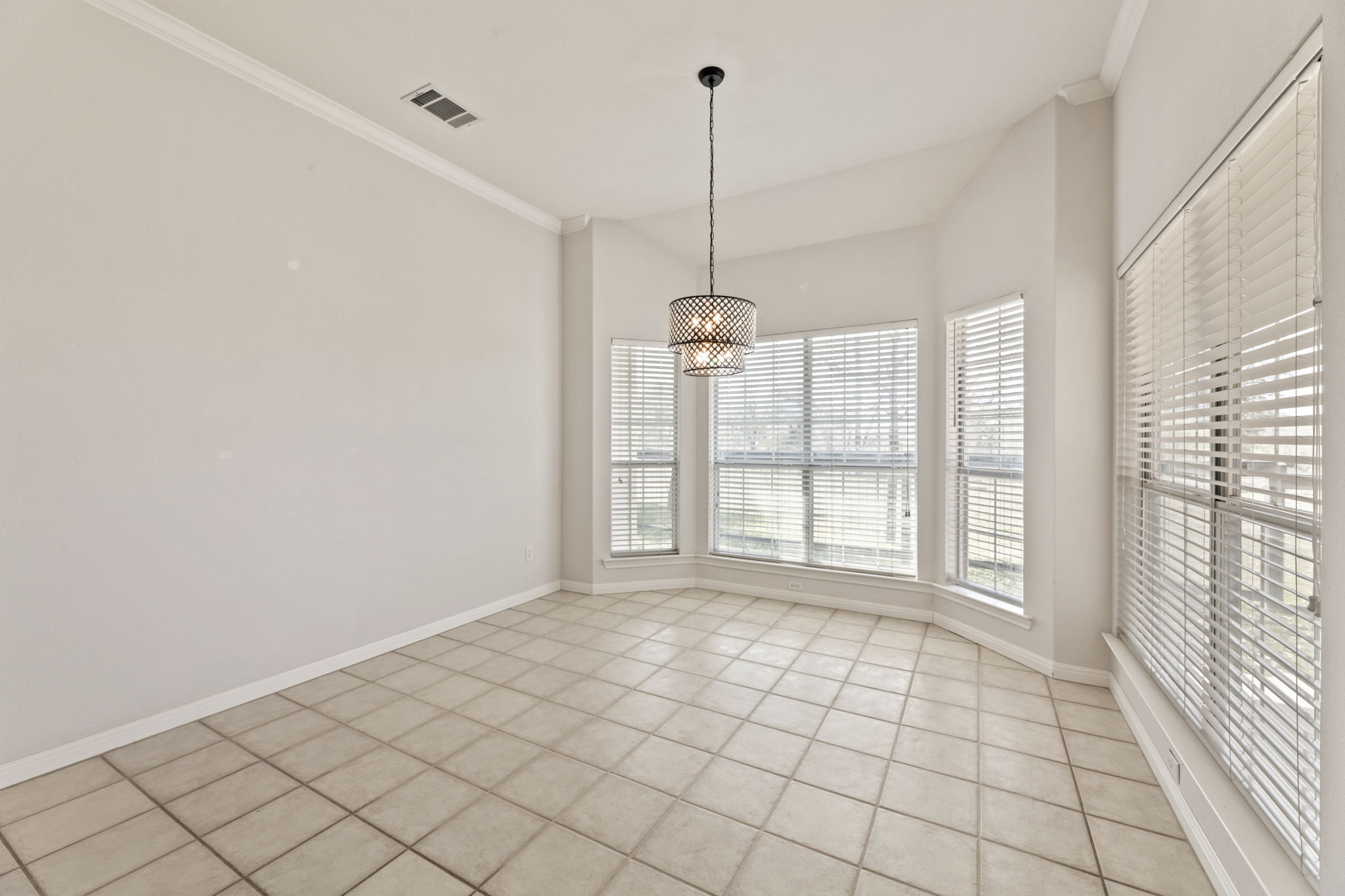 109 Riverview Drive Georgetown, TX 78628 - Photo 13 of 35 Spare room featuring crown molding and light tile patterned flooring