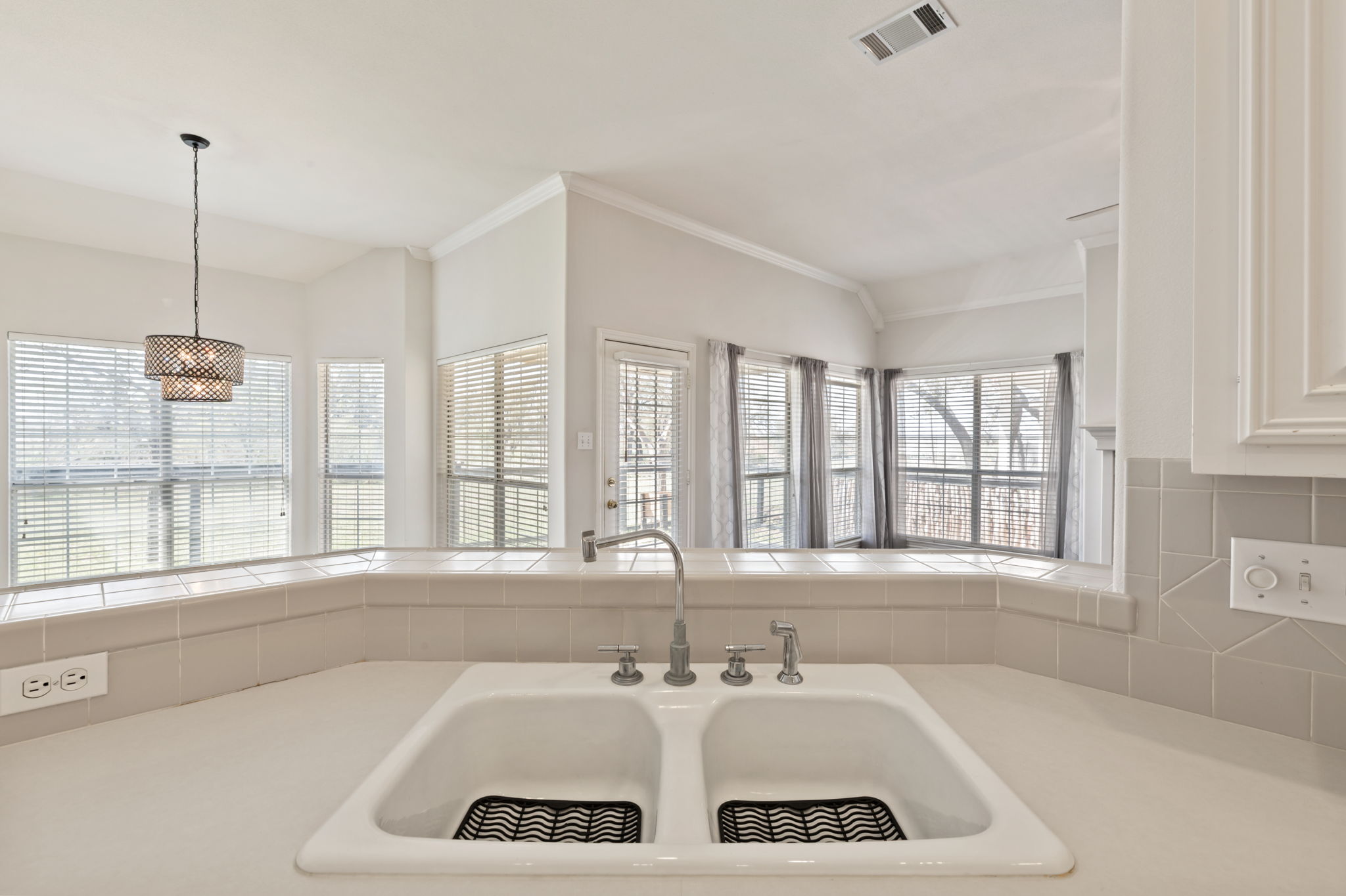 109 Riverview Drive Georgetown, TX 78628 - Photo 15 of 35 Kitchen featuring light countertops, white cabinets, and hanging light fixtures