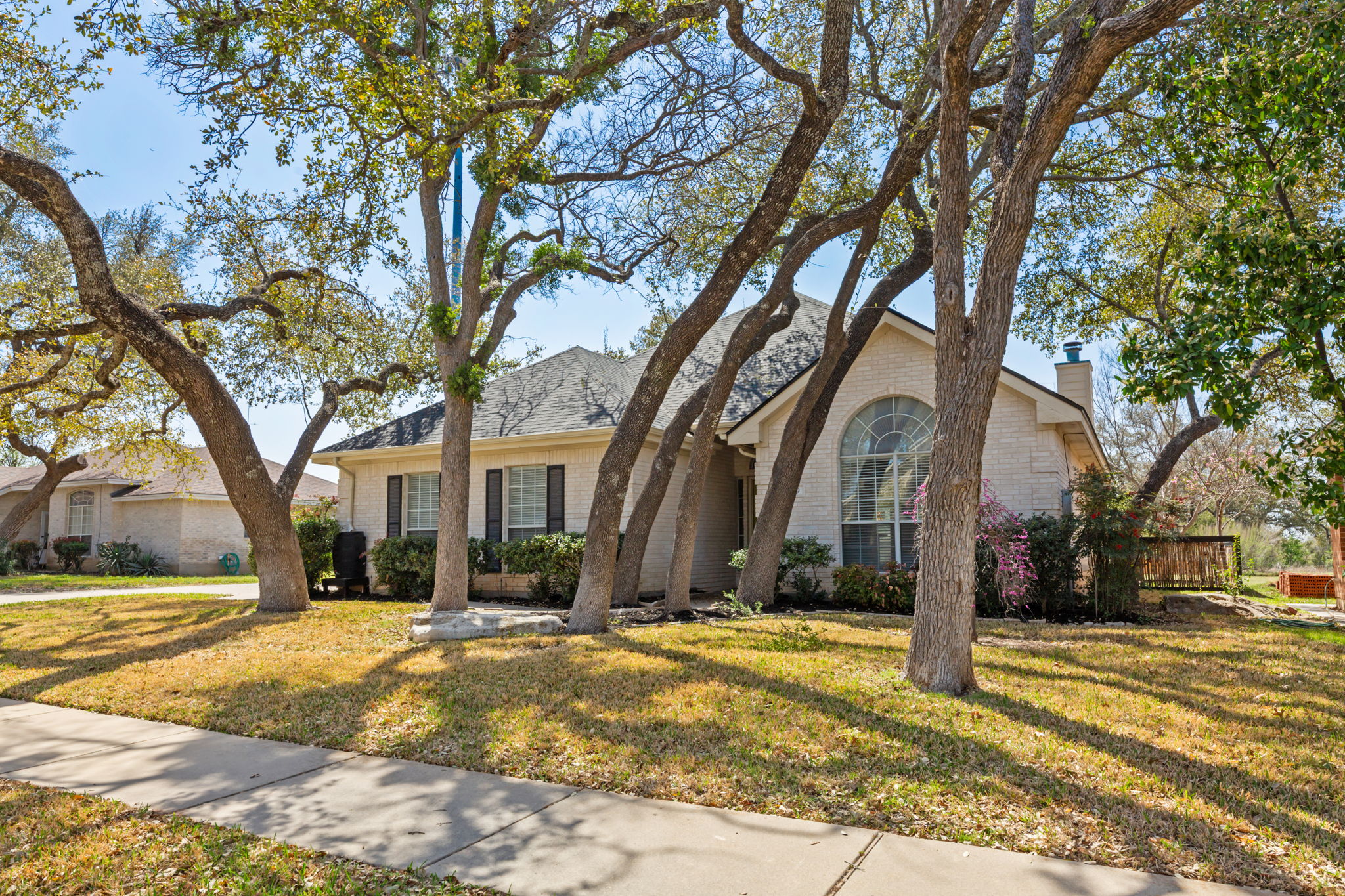 109 Riverview Drive Georgetown, TX 78628 - Photo 3 of 35 View of front of house with brick siding, a chimney, and a front yard