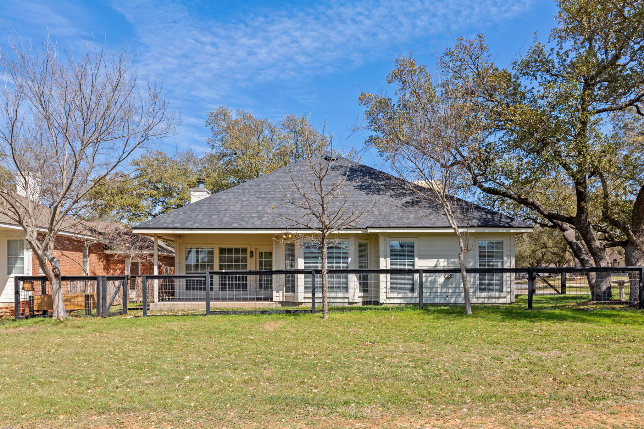109 Riverview Drive Georgetown, TX 78628 - Photo 33 of 35 Back of house featuring a chimney, a fenced backyard, a shingled roof, and a patio