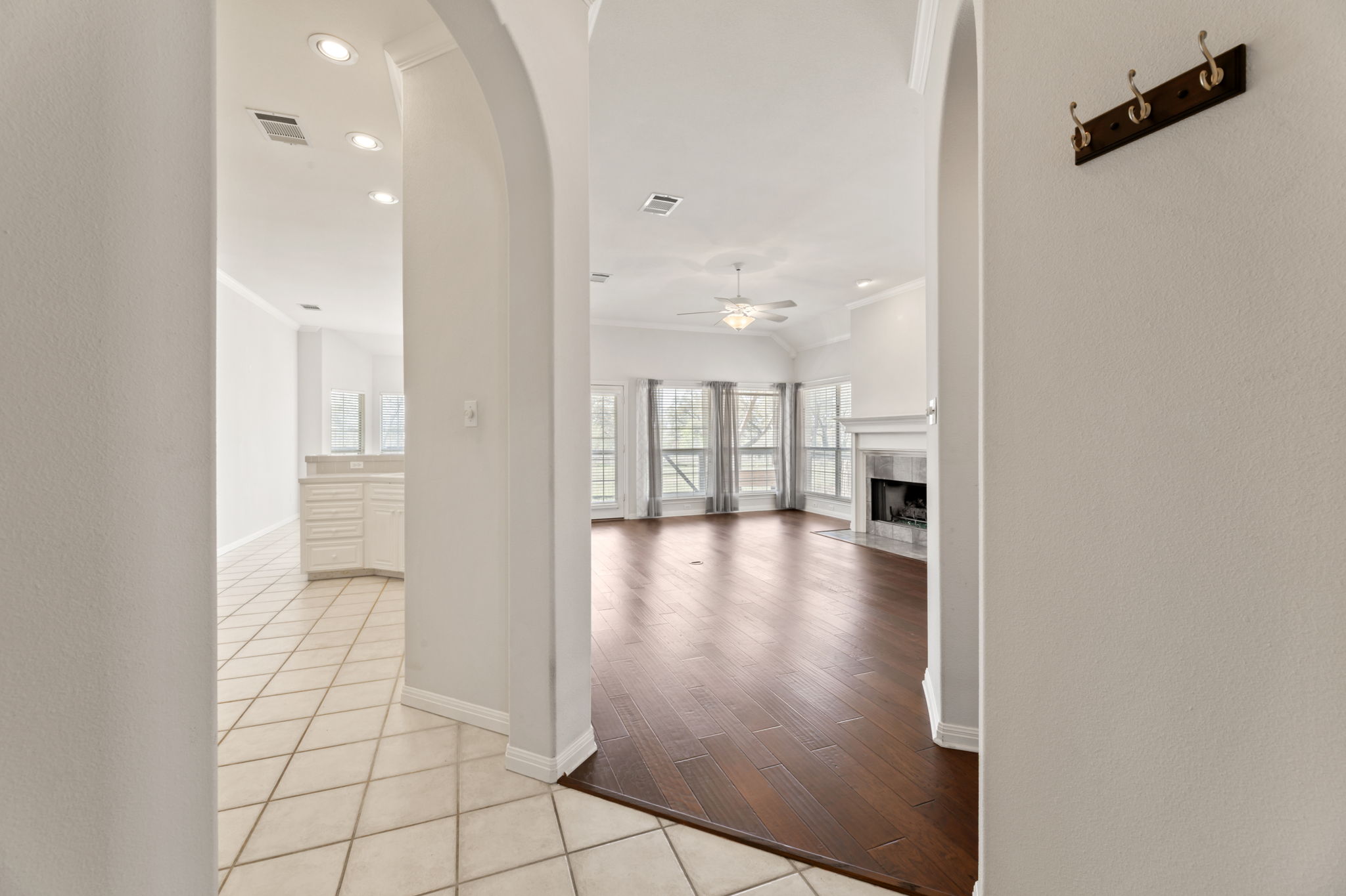 109 Riverview Drive Georgetown, TX 78628 - Photo 6 of 35 Corridor featuring light tile patterned floors, recessed lighting, arched walkways, and crown molding