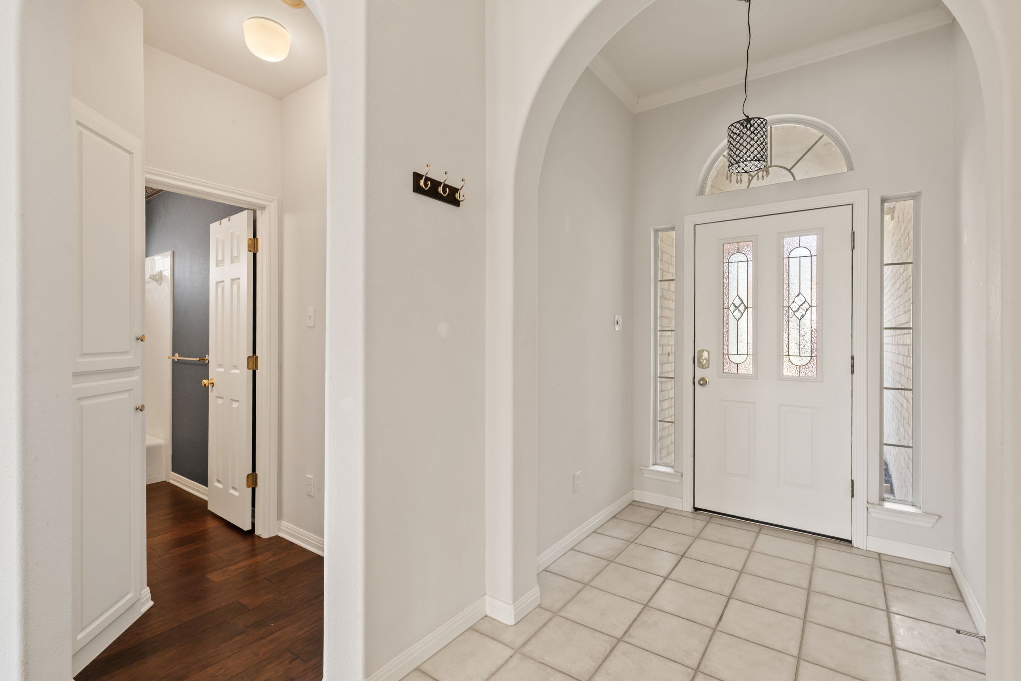 109 Riverview Drive Georgetown, TX 78628 - Photo 7 of 35 Foyer featuring arched walkways, ornamental molding, and light wood-style floors