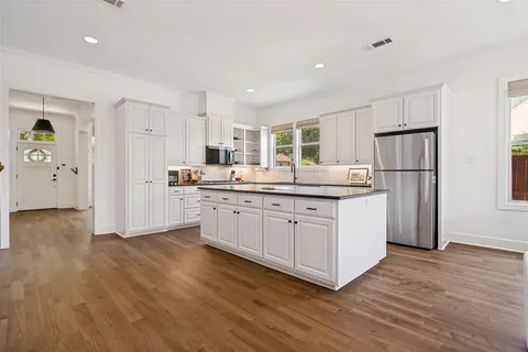 a kitchen with white cabinets and white appliances