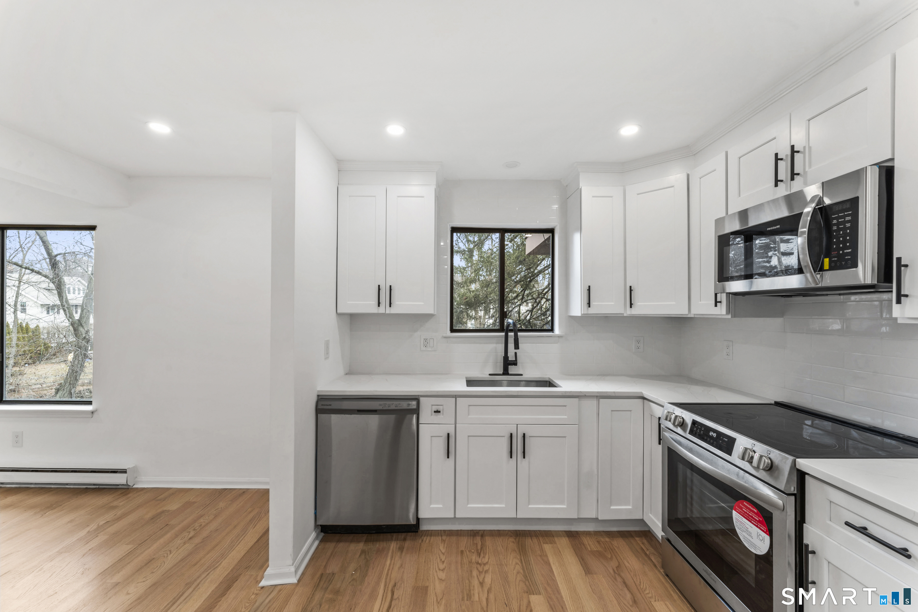 100 Maple Tree Avenue, Unit 7 Stamford, CT 06906 - Photo 11 of 38 a kitchen with a sink stove and microwave