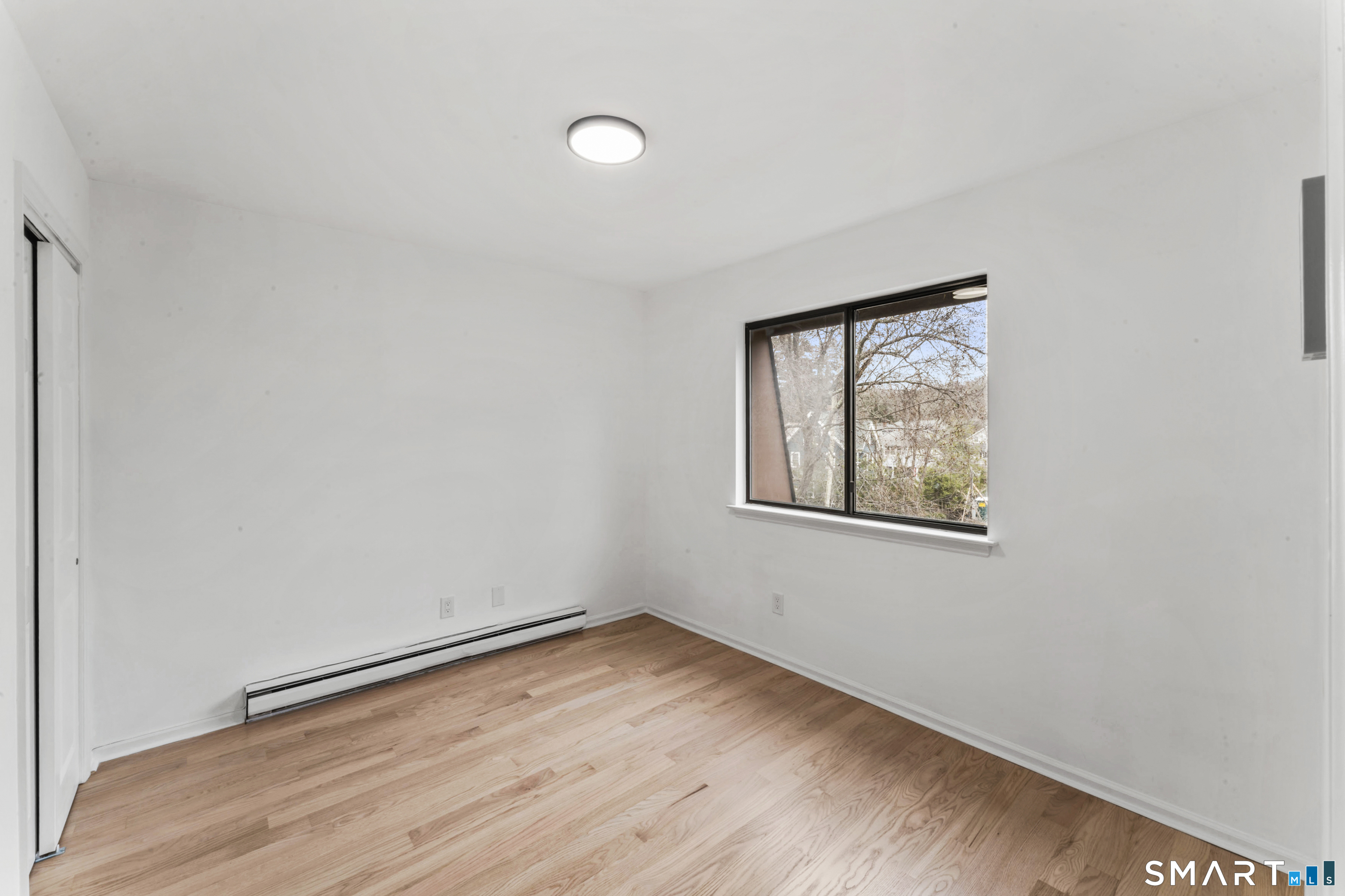 100 Maple Tree Avenue, Unit 7 Stamford, CT 06906 - Photo 21 of 38 an empty room with a window