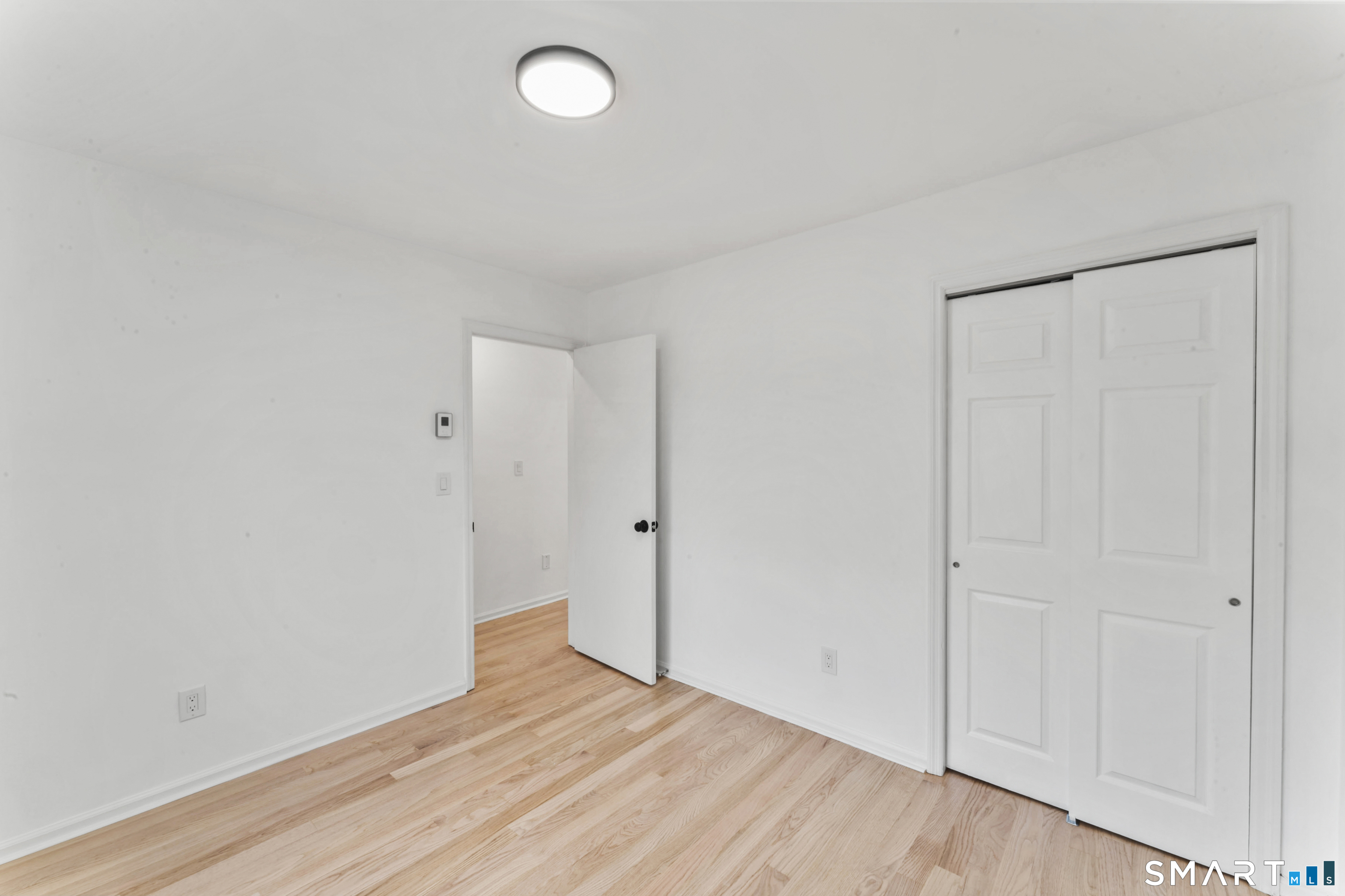 100 Maple Tree Avenue, Unit 7 Stamford, CT 06906 - Photo 22 of 38 a view of an empty room and wooden floor