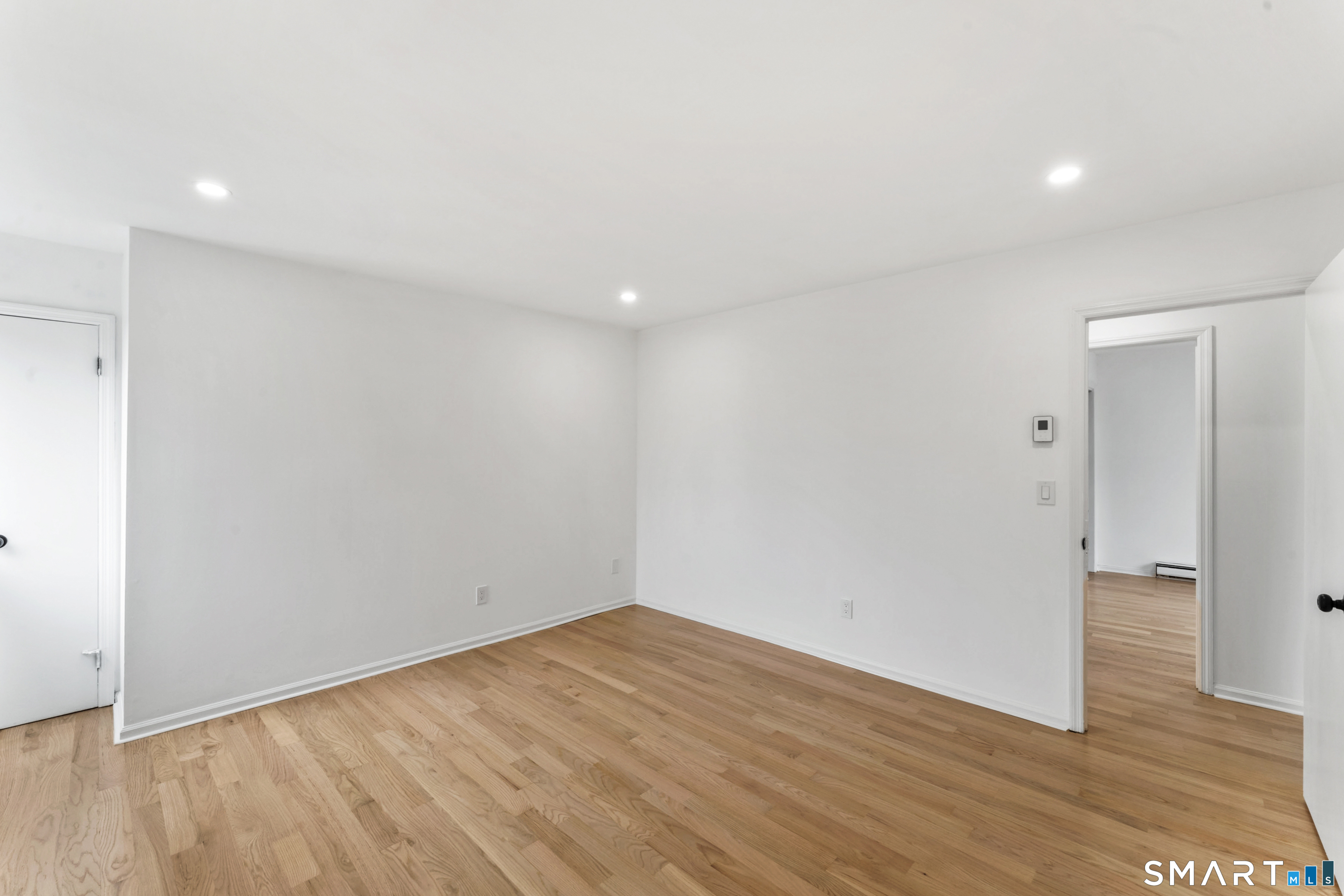 100 Maple Tree Avenue, Unit 7 Stamford, CT 06906 - Photo 27 of 38 a view of empty room with wooden floor and space