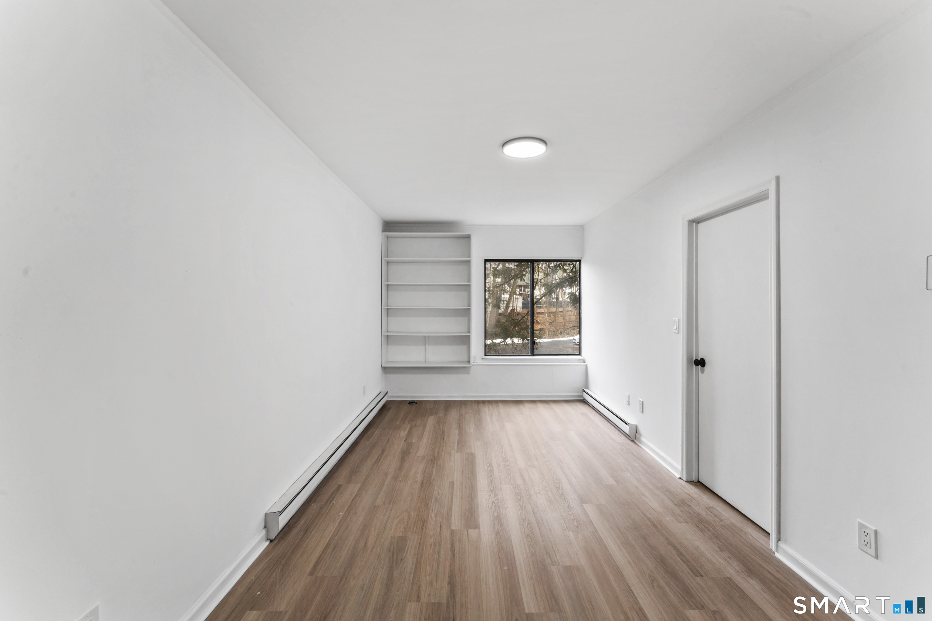 100 Maple Tree Avenue, Unit 7 Stamford, CT 06906 - Photo 29 of 38 a view of a room with wooden floor and window