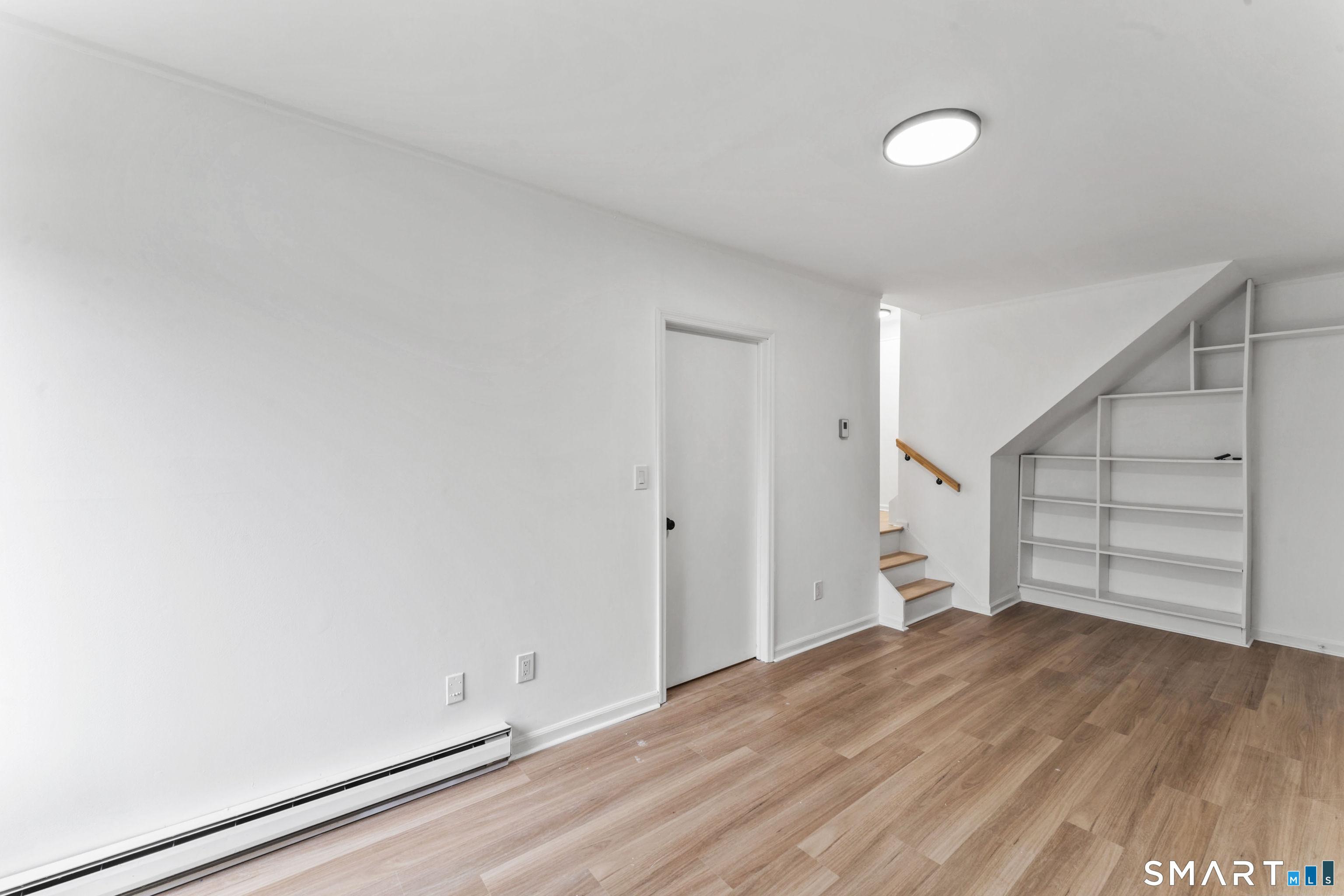 100 Maple Tree Avenue, Unit 7 Stamford, CT 06906 - Photo 30 of 38 a view of empty room with wooden floor and window