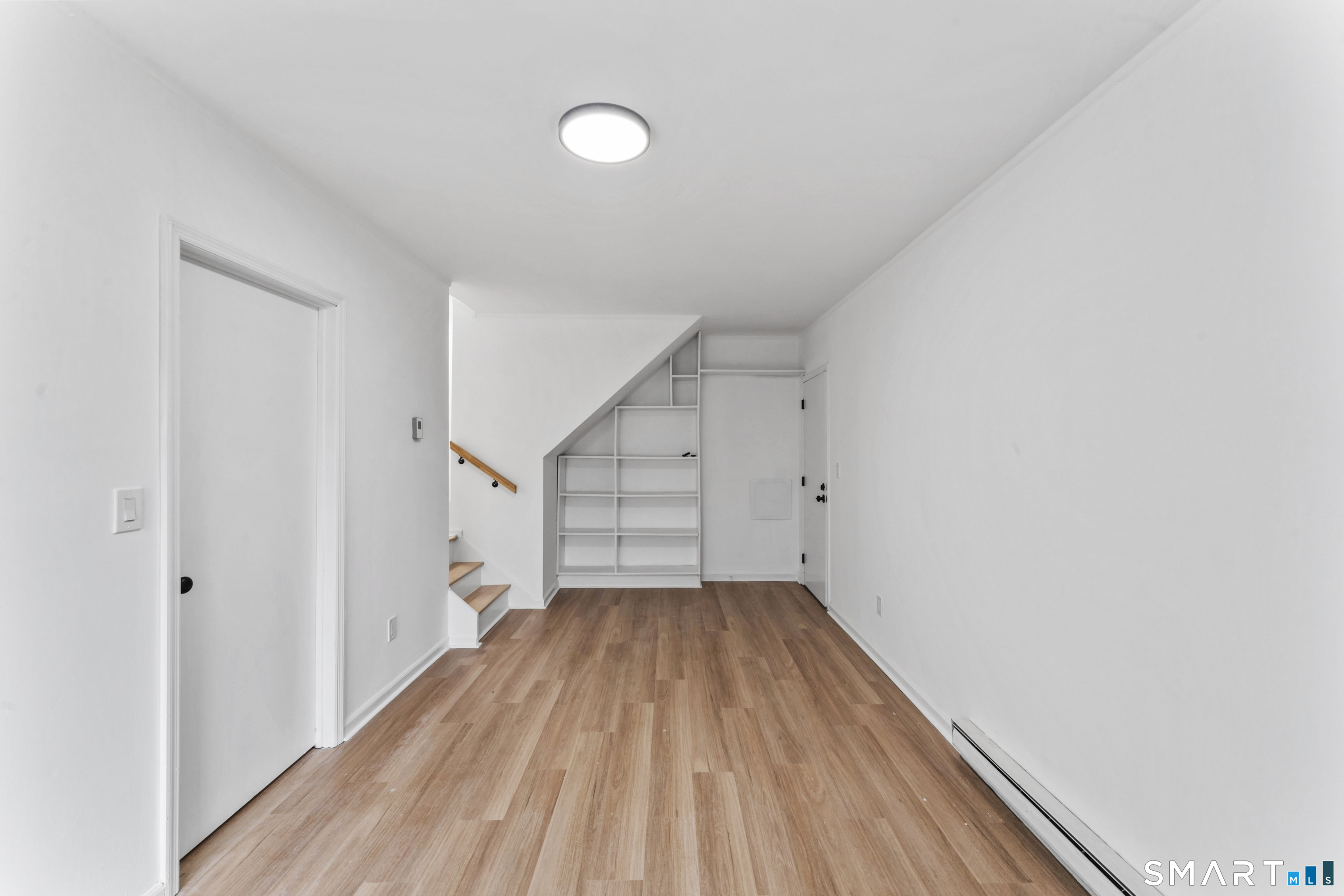 100 Maple Tree Avenue, Unit 7 Stamford, CT 06906 - Photo 31 of 38 a view of a room with wooden floors and white walls