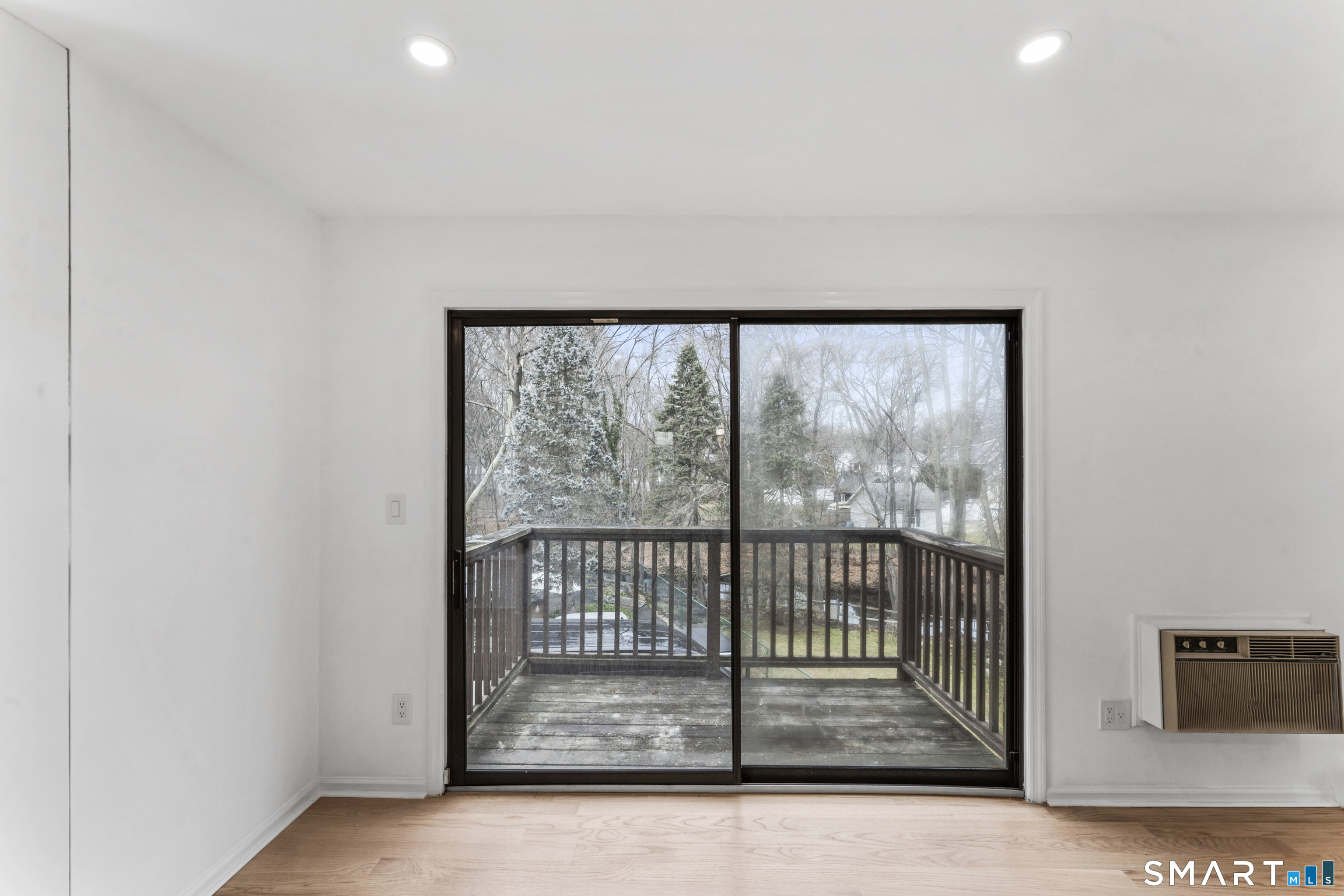 100 Maple Tree Avenue, Unit 7 Stamford, CT 06906 - Photo 4 of 38 a view of empty room with wooden floor