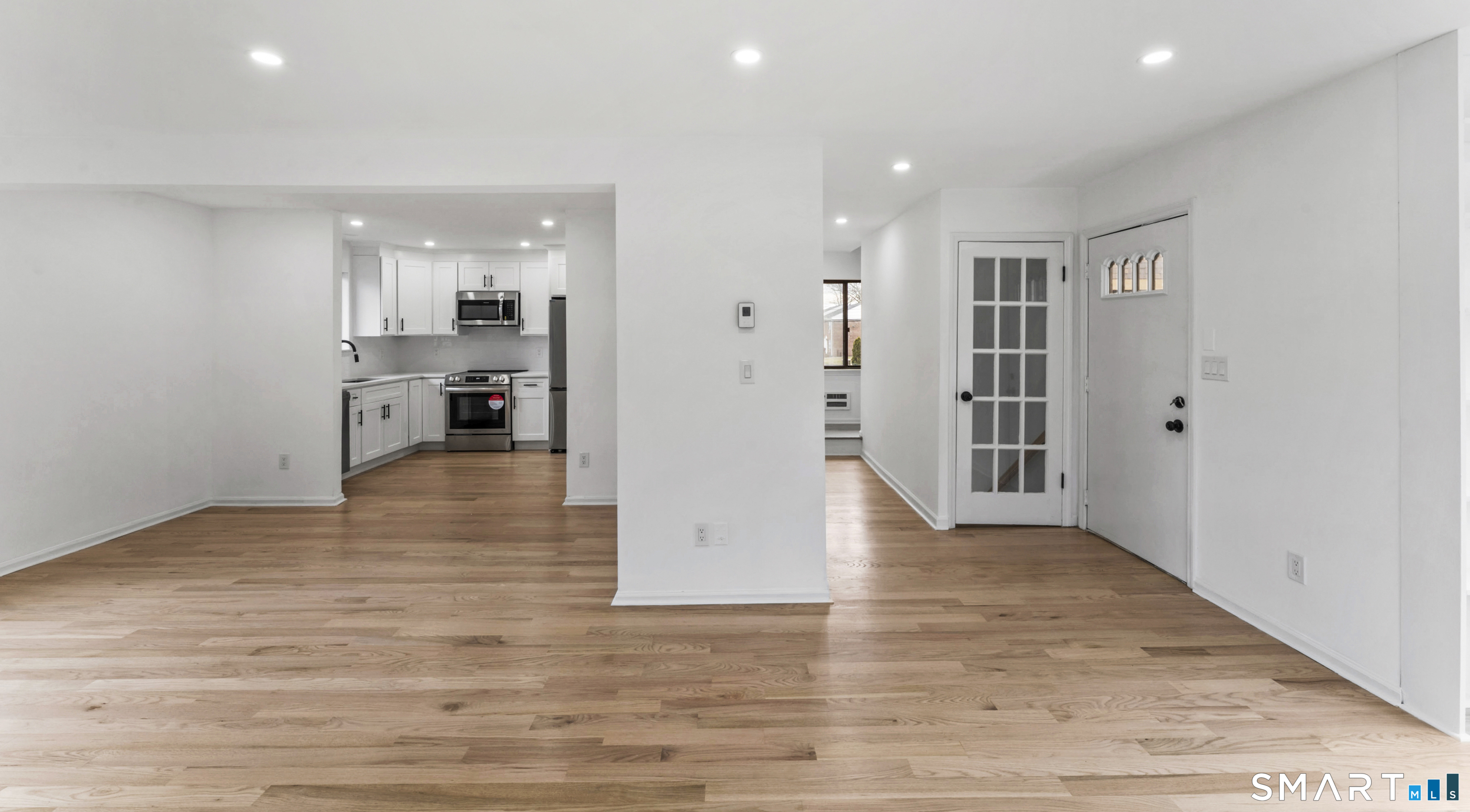 100 Maple Tree Avenue, Unit 7 Stamford, CT 06906 - Photo 5 of 38 an empty room with wooden floor and windows