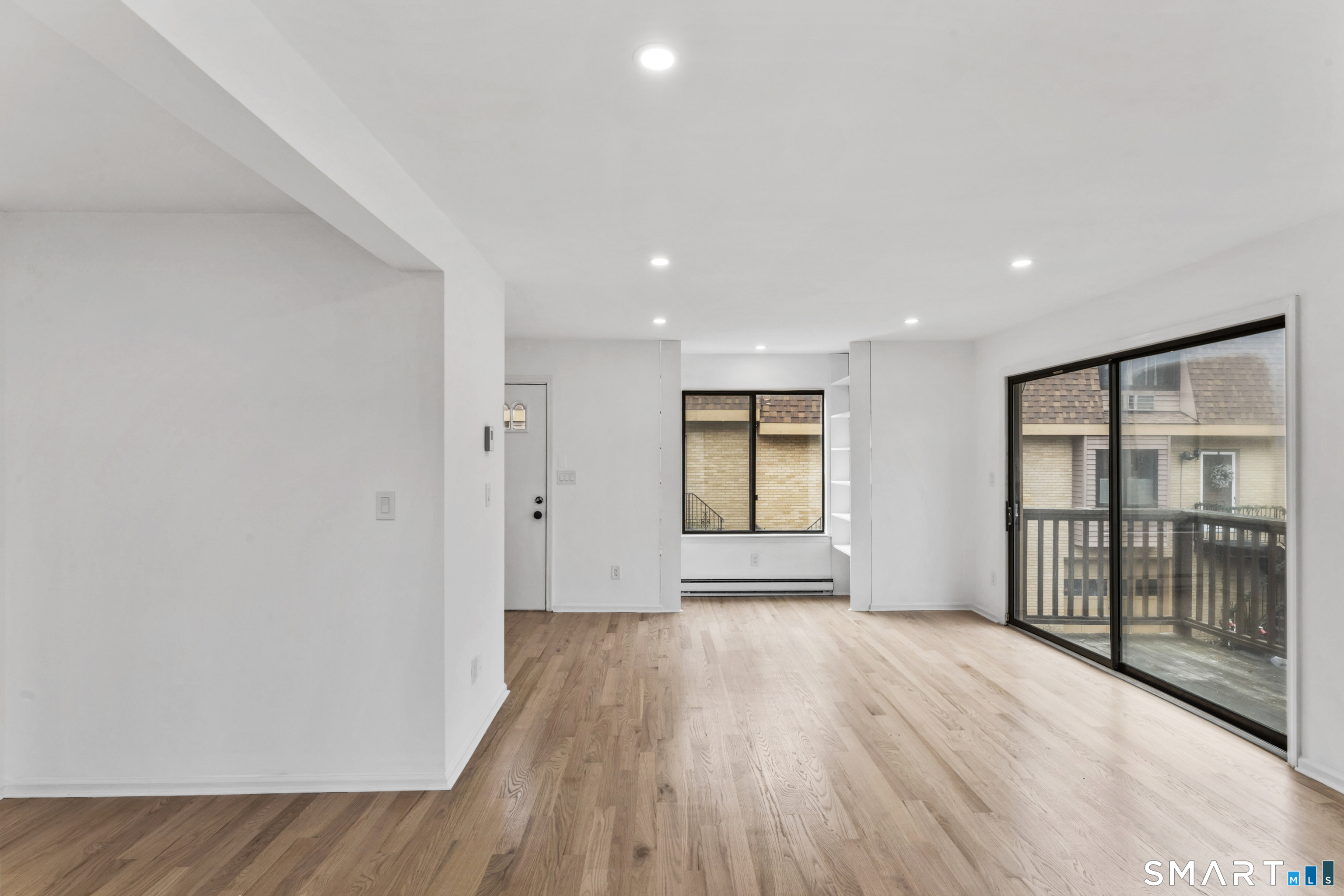 100 Maple Tree Avenue, Unit 7 Stamford, CT 06906 - Photo 7 of 38 a view of empty room with wooden floor