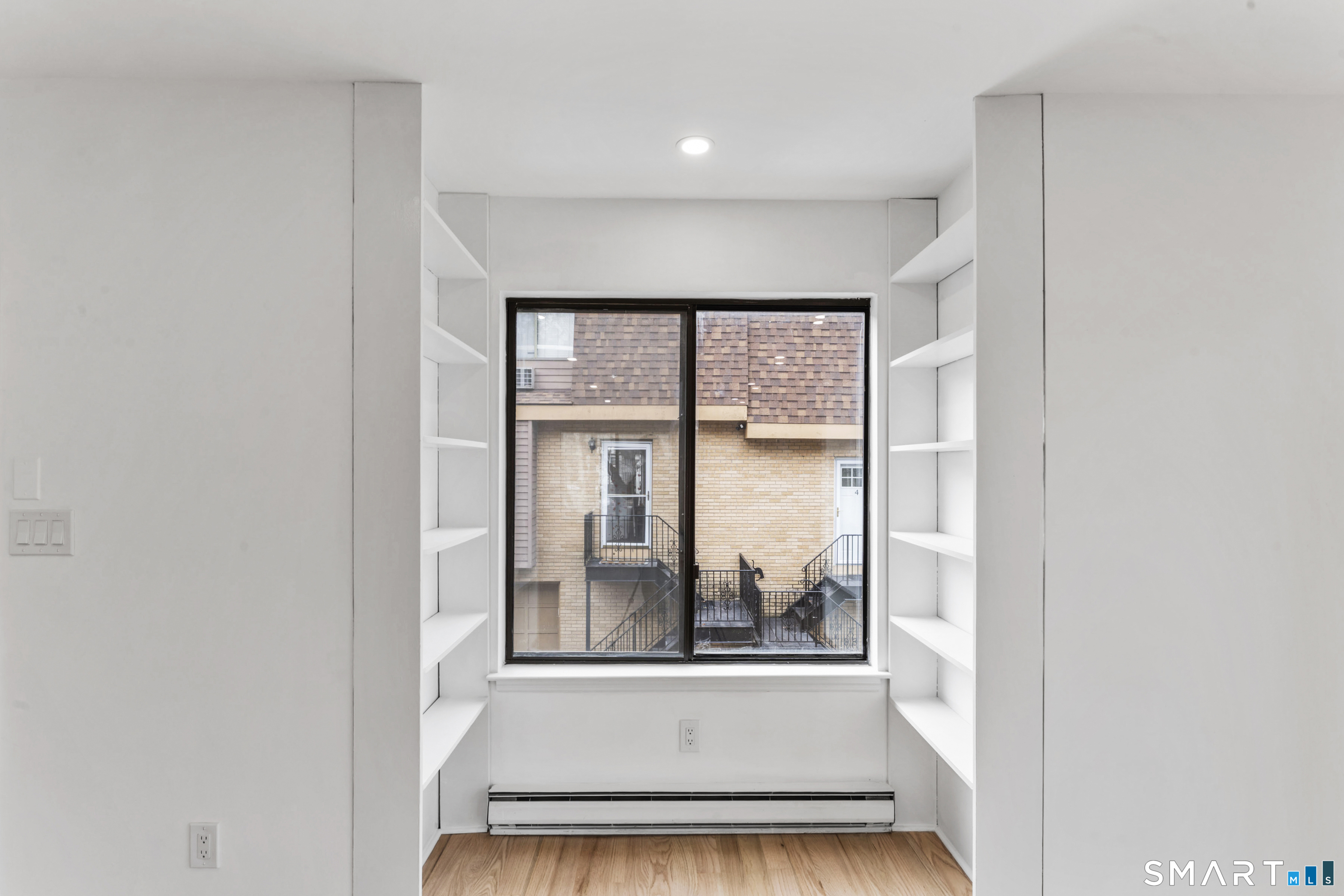 100 Maple Tree Avenue, Unit 7 Stamford, CT 06906 - Photo 8 of 38 a view of a livingroom with a fireplace and a window