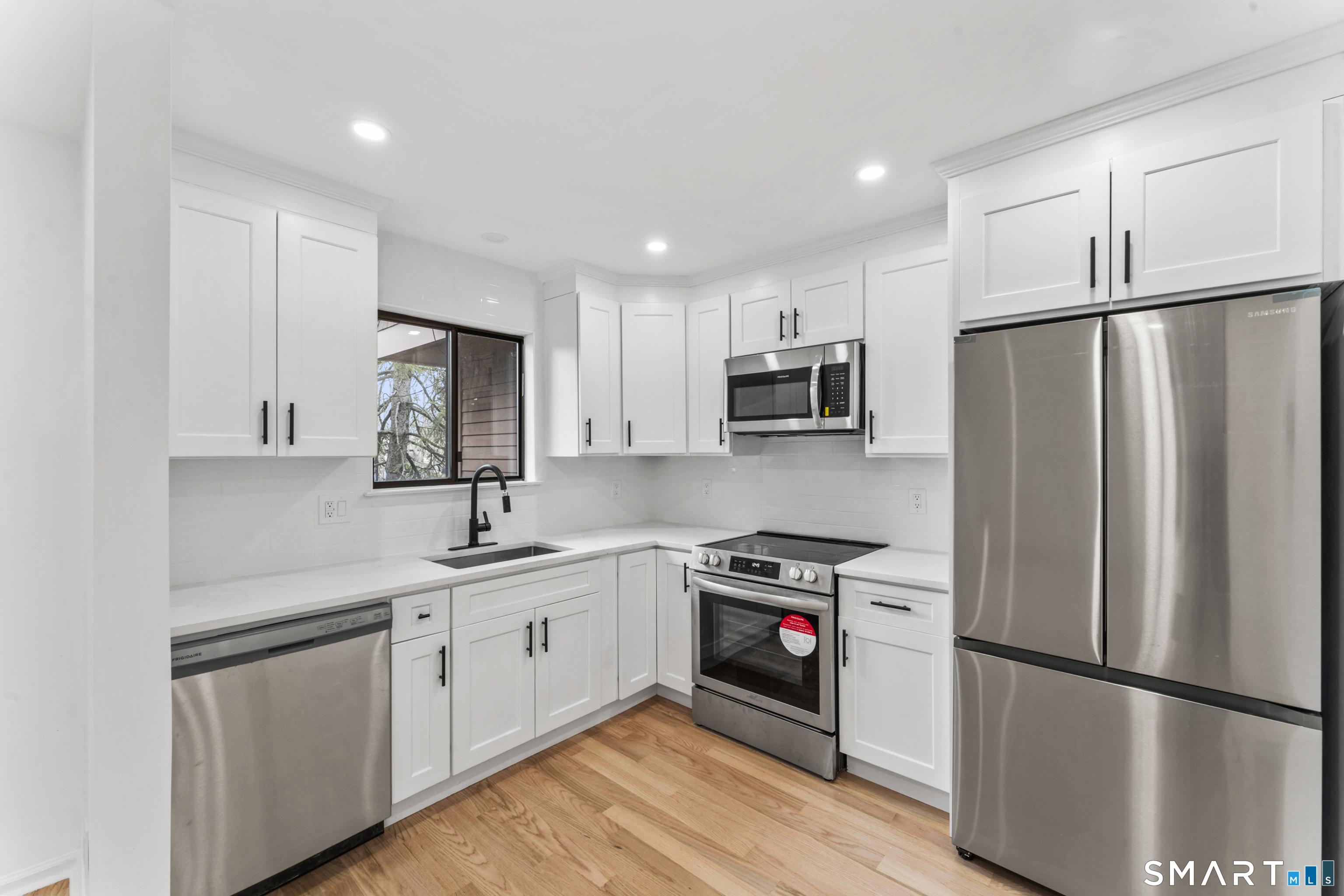 100 Maple Tree Avenue, Unit 7 Stamford, CT 06906 - Photo 10 of 38 a kitchen with stainless steel appliances a refrigerator sink and microwave